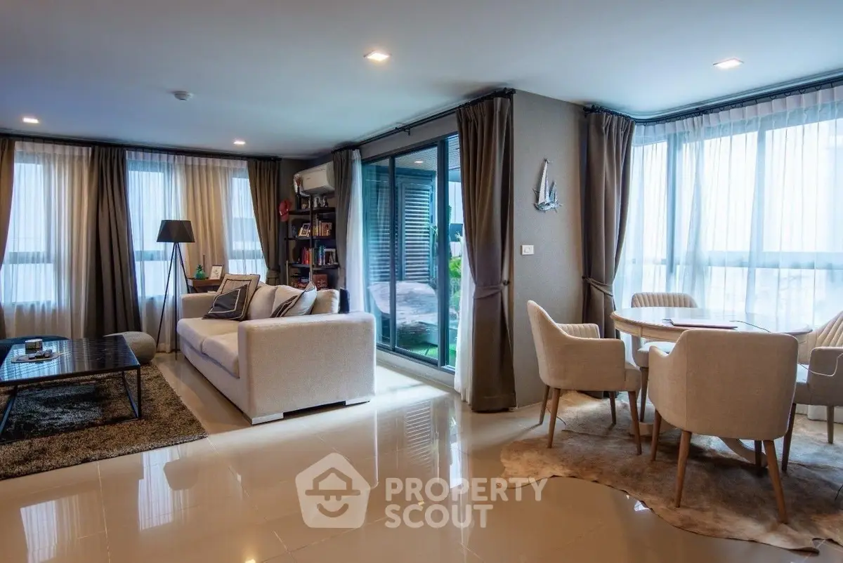 Spacious modern living room with elegant decor and large windows