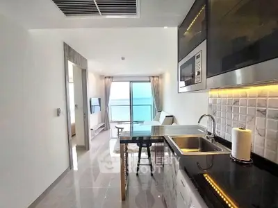 Modern open kitchen with sleek design and ocean view balcony