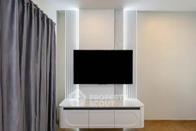 Modern living room with sleek TV unit and elegant curtains