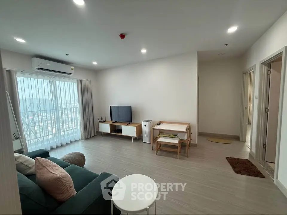Spacious modern living room with natural light and stylish furniture