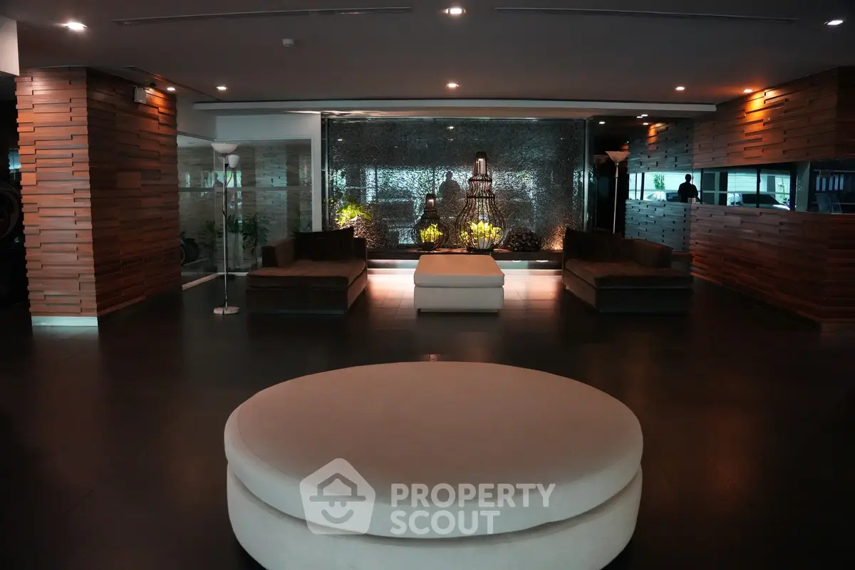 Luxurious modern lobby with elegant seating and ambient lighting in a high-end residential building.