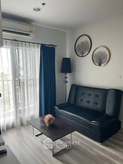 Modern living room with black leather sofa and stylish decor