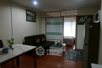 Cozy apartment with open living room and bedroom, featuring modern decor and natural light.