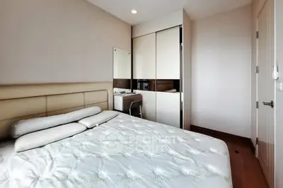 Cozy bedroom with modern furnishings and ample natural light
