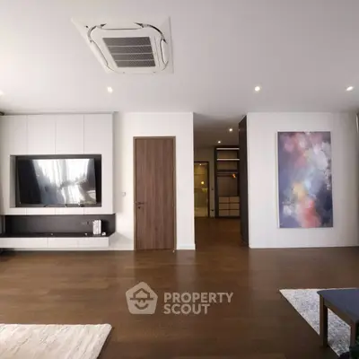 Spacious modern living room with wooden flooring and stylish decor