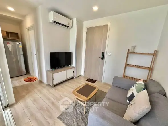 Modern living room with cozy sofa, TV, and air conditioning in a stylish apartment.