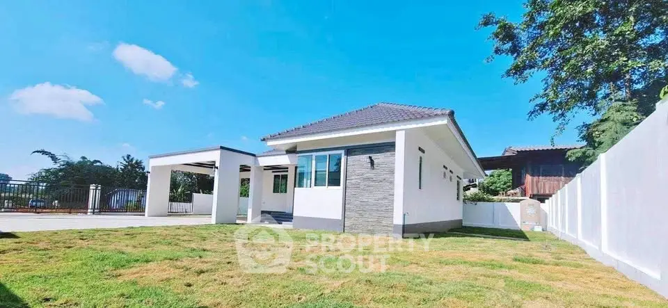 Charming single-story home with spacious yard and modern exterior design.