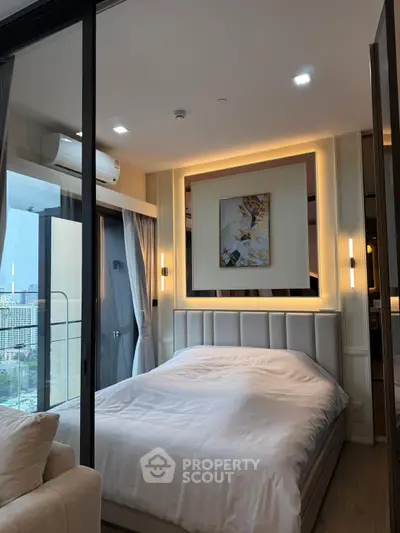 Luxurious bedroom with modern decor and city view from balcony