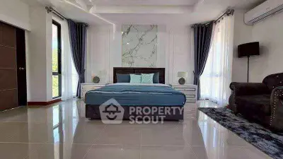 Luxurious modern bedroom with elegant decor and large windows for natural light.