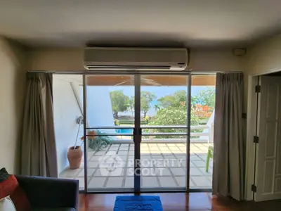 Spacious living room with sliding glass doors leading to a scenic balcony view.