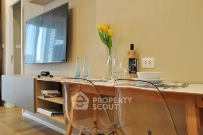 Modern living room with wall-mounted TV and elegant dining setup