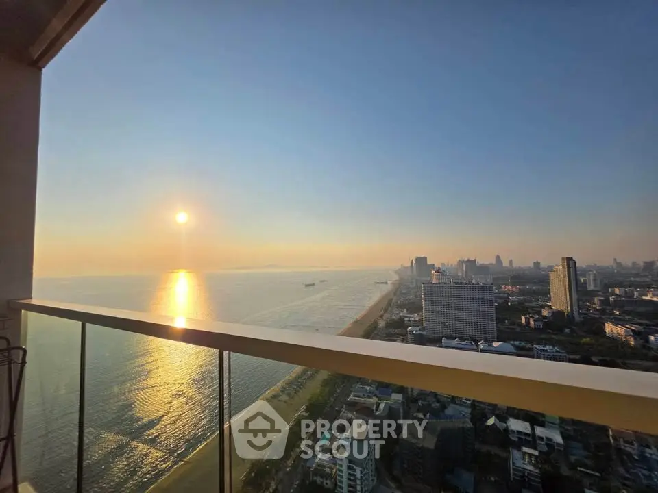 Stunning ocean view from high-rise balcony at sunset, perfect for luxury living.