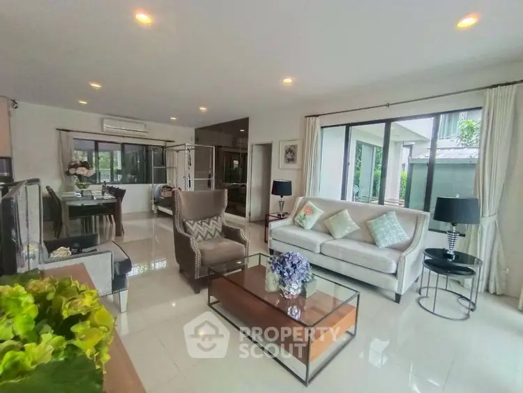 Spacious living room with modern decor and large windows for natural light.