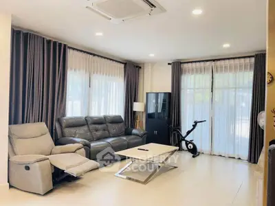 Modern living room with sleek furniture and exercise bike, perfect for relaxation and fitness.
