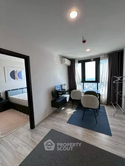 Modern living room with city view and adjacent bedroom in stylish apartment