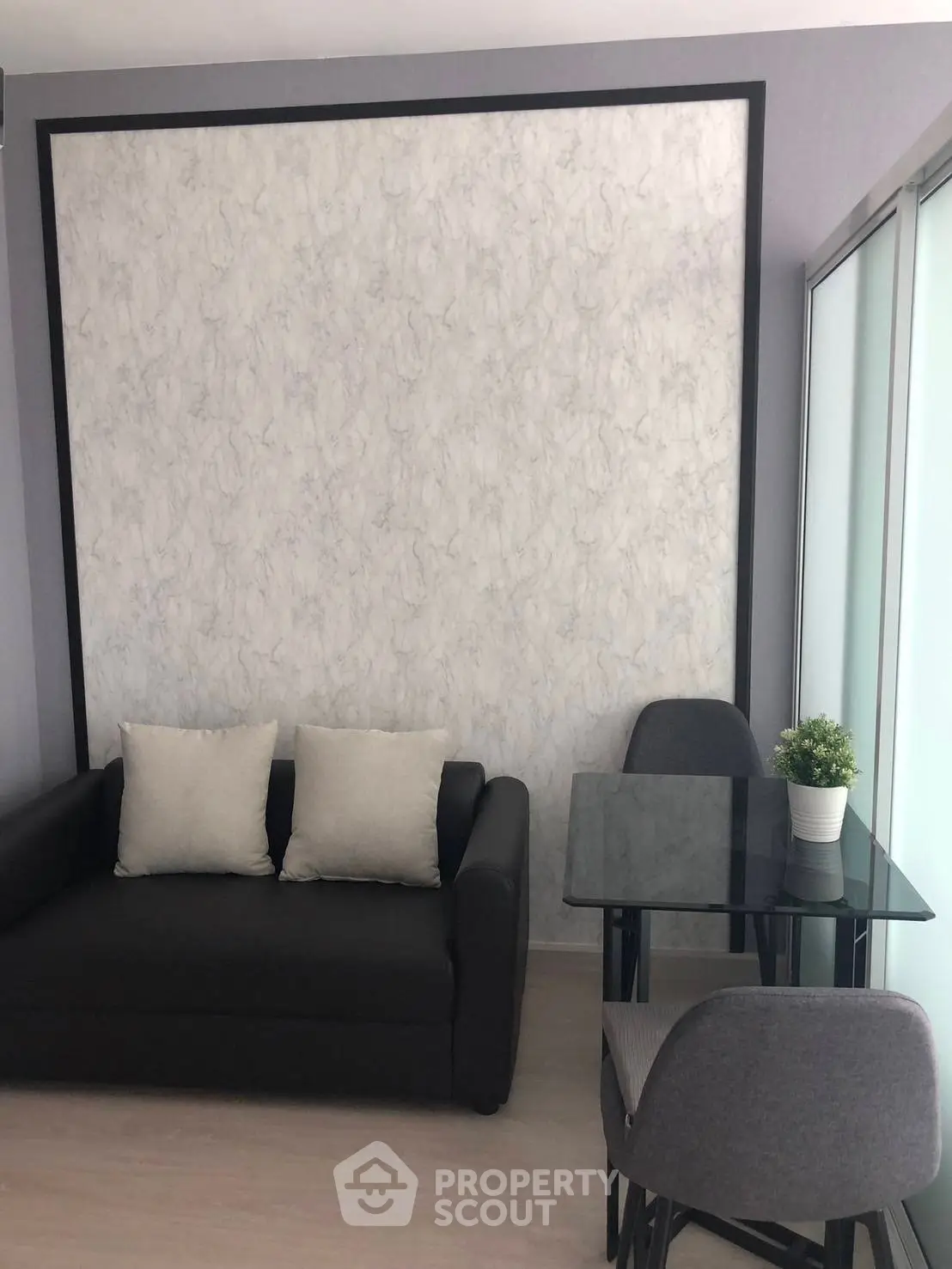Modern living room with sleek sofa and dining area, perfect for urban living.