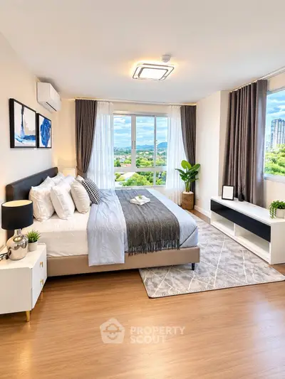 Luxurious bedroom with stunning view, modern decor, and ample natural light in high-rise apartment.