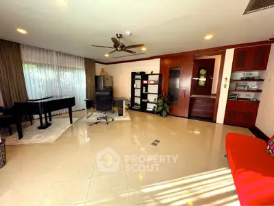 Spacious living room with piano and modern decor, ideal for entertaining and relaxation.