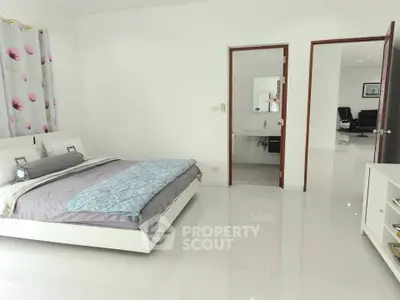 Spacious modern bedroom with ensuite bathroom and sleek design
