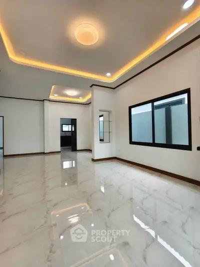 Spacious modern living room with elegant lighting and glossy marble flooring