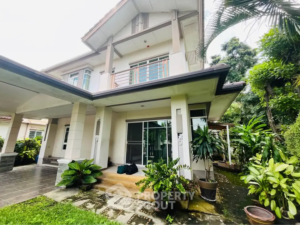 Charming two-story house with lush garden and spacious patio, perfect for family living.