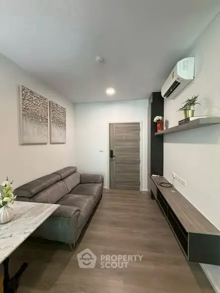 Modern living room with sleek furniture and air conditioning in a stylish apartment.