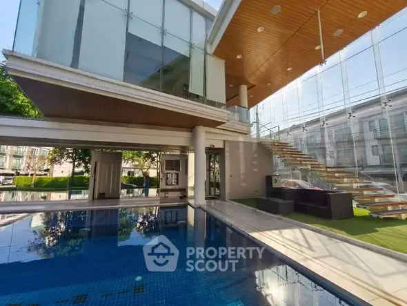 Luxurious modern home with stunning pool and glass architecture, perfect for upscale living.