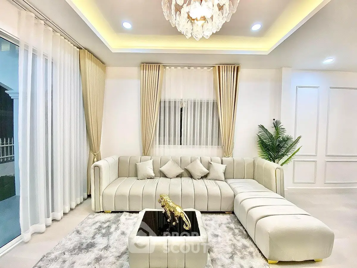 Luxurious living room with elegant chandelier and plush sectional sofa