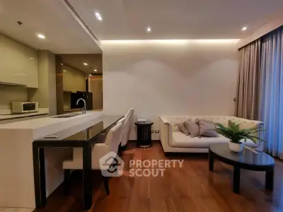 Luxurious modern living room with open kitchen, elegant sofa, and stylish decor in a high-end apartment.