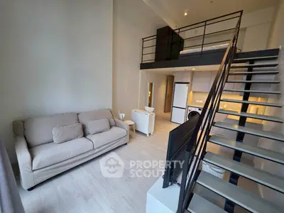 Modern loft apartment with mezzanine bedroom and stylish open living area.