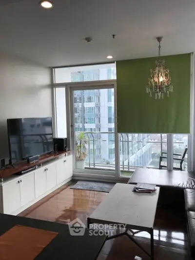 Modern living room with large window and balcony view in urban apartment