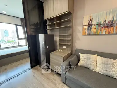 Modern apartment interior with stylish living room and kitchen area, featuring sleek furniture and city view.