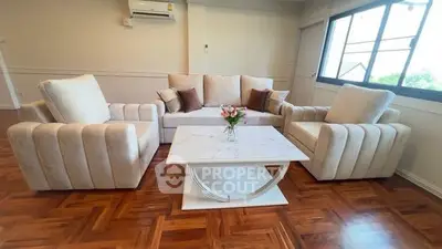 Elegant living room with plush seating and stylish coffee table on wooden flooring.
