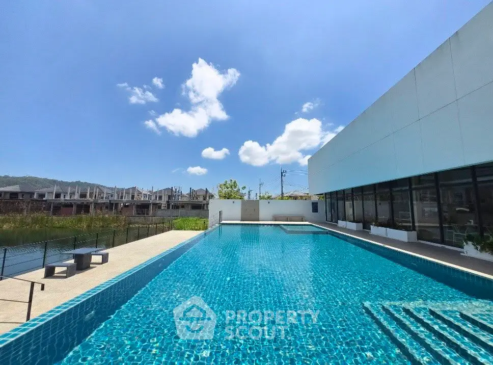 Luxurious outdoor pool with modern building and scenic view, perfect for relaxation and leisure.