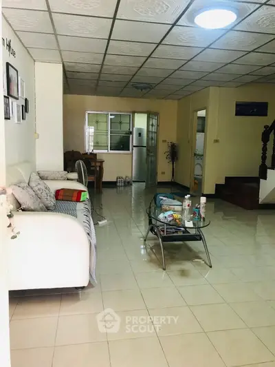 Spacious living room with tiled floor and cozy seating area