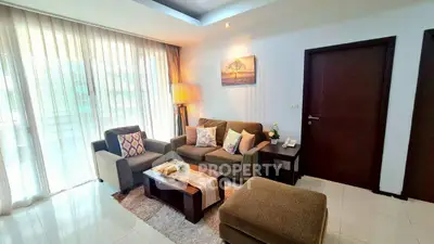 Elegant living room with cozy seating and natural light in modern apartment.