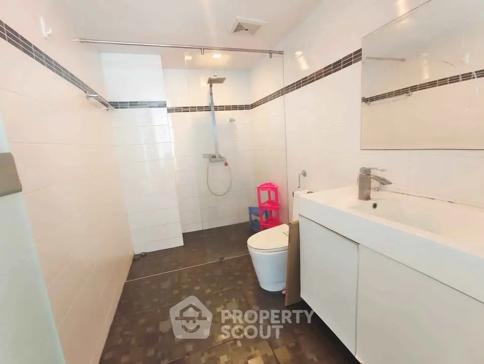 Modern bathroom with sleek fixtures and spacious shower area