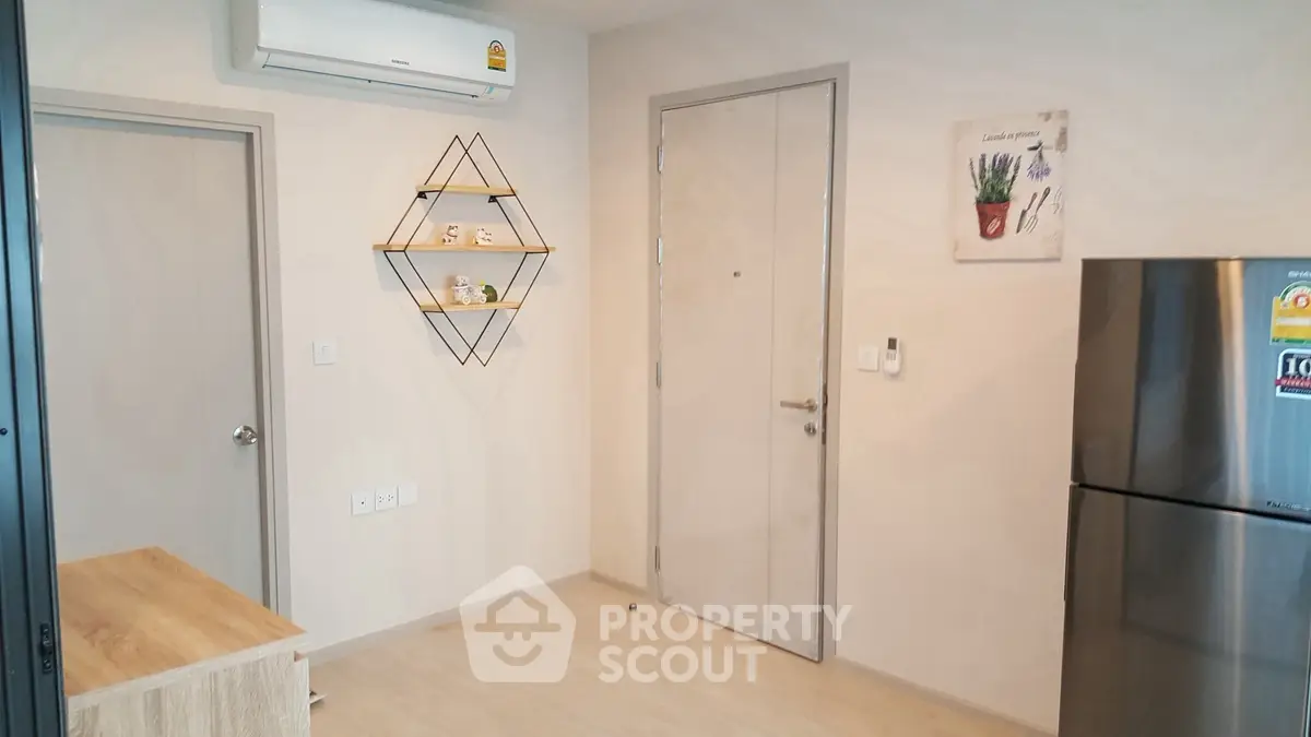 Modern apartment interior with air conditioning and sleek refrigerator