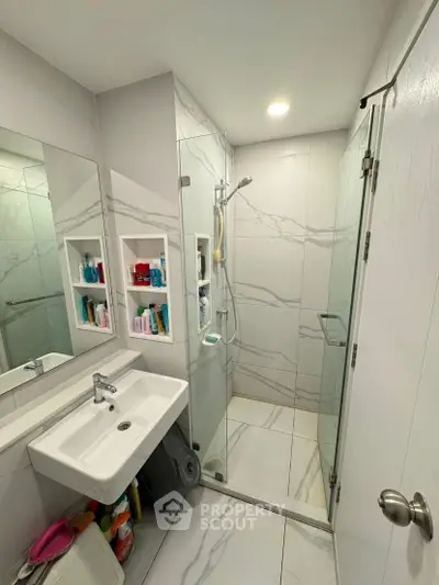 Modern bathroom with sleek shower and elegant marble tiles