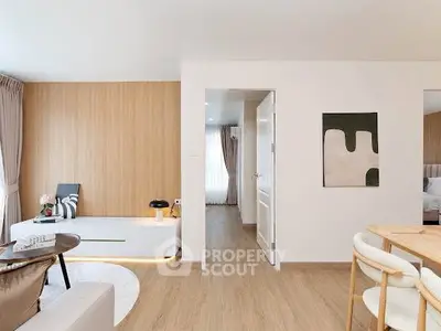 Modern living room with wooden flooring and stylish decor in a cozy apartment.