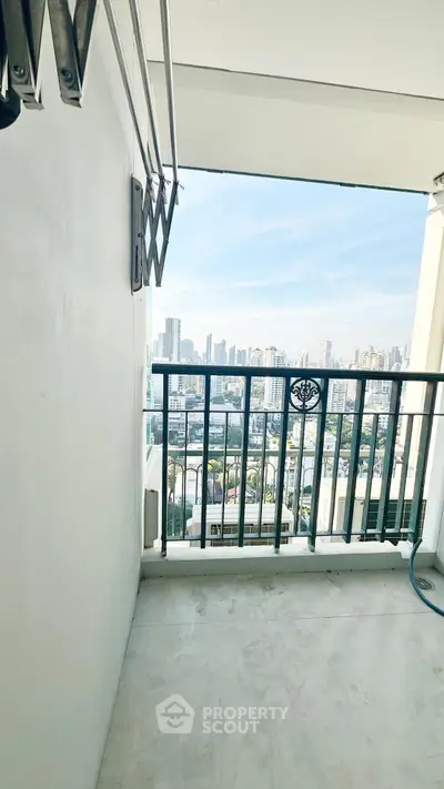 Spacious balcony with stunning city skyline view, perfect for relaxation and enjoying urban living.