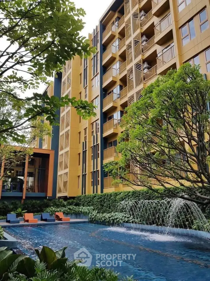 Luxurious apartment building with pool and lush greenery, perfect for modern living.