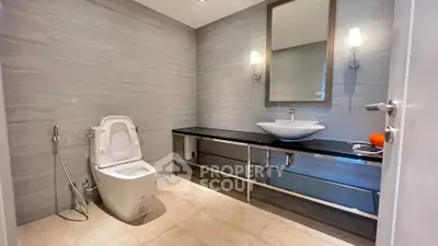 Spacious modern bathroom with sleek fixtures and elegant lighting