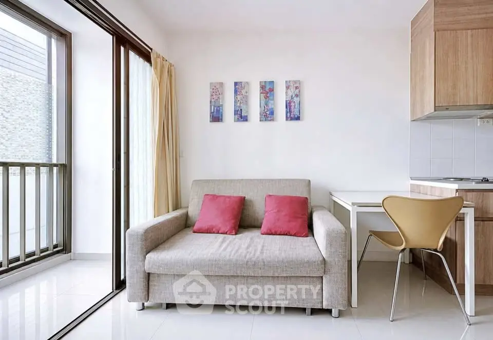 Modern living room with cozy sofa, stylish decor, and open kitchen layout in a bright apartment.