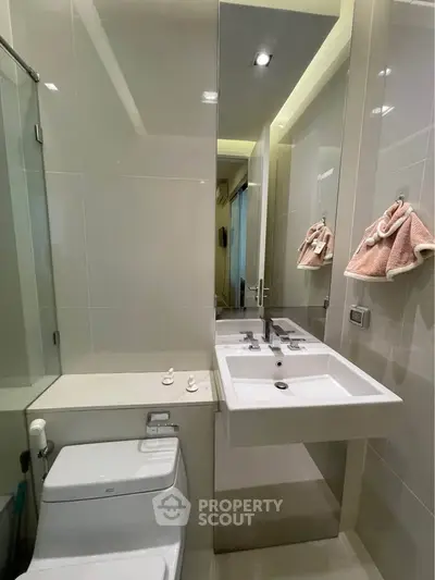 Modern bathroom with sleek fixtures and elegant design, featuring a stylish sink and toilet.