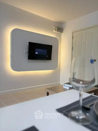 Modern living room with stylish wall-mounted TV and ambient lighting