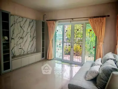 Spacious living room with elegant decor and garden view, perfect for relaxation and entertaining guests.