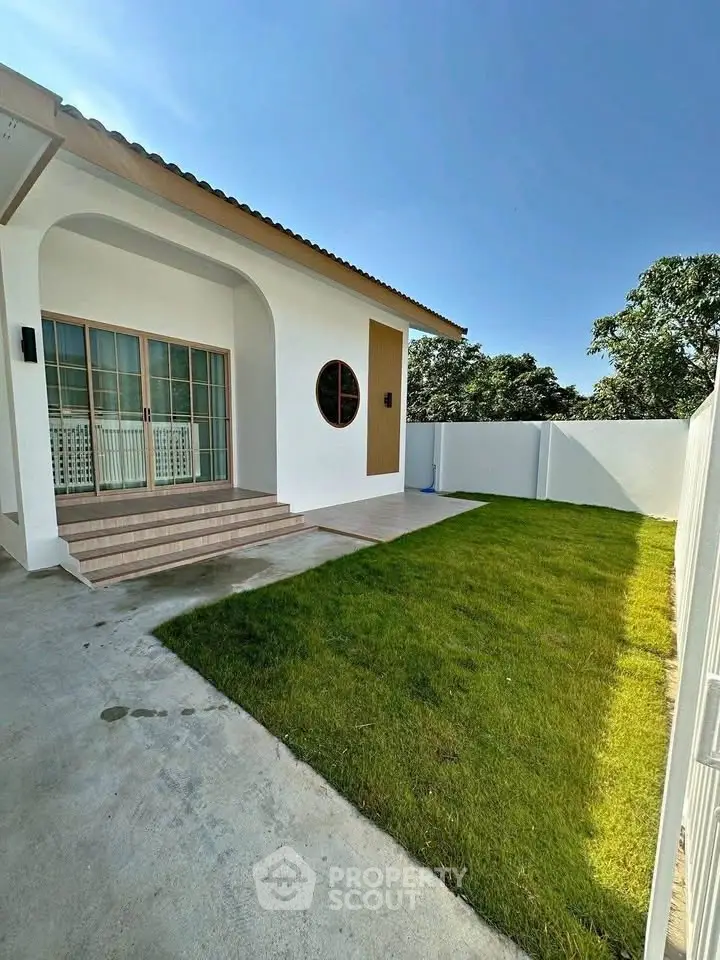 Charming single-story home with lush green lawn and modern architecture