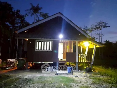 Charming rustic cabin with warm lighting in a serene natural setting, perfect for a tranquil retreat.