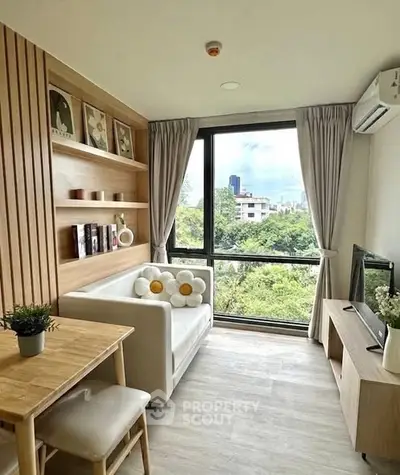 Charming living room with city view, cozy seating, and modern decor in a bright apartment.
